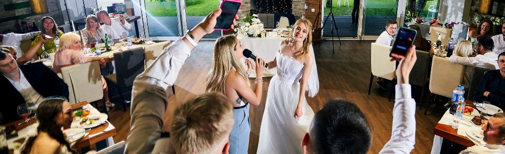 Wedding photographer documenting a bride during a wedding reception.