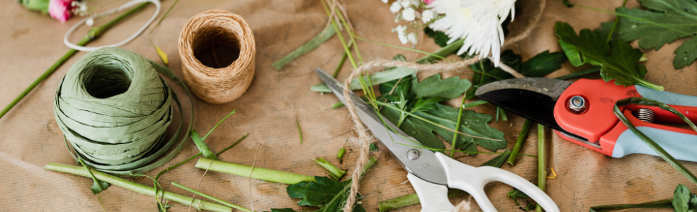 Florist workspace with floral design tools and fresh flowers prepared for creating