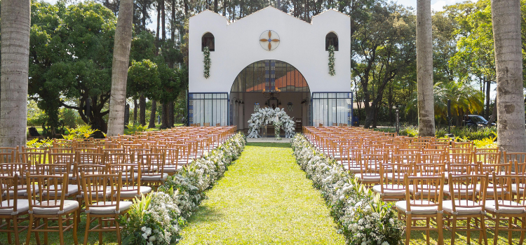 Chapel wedding venue with outdoor ceremony seating and landscaped aisle leading to the chapel