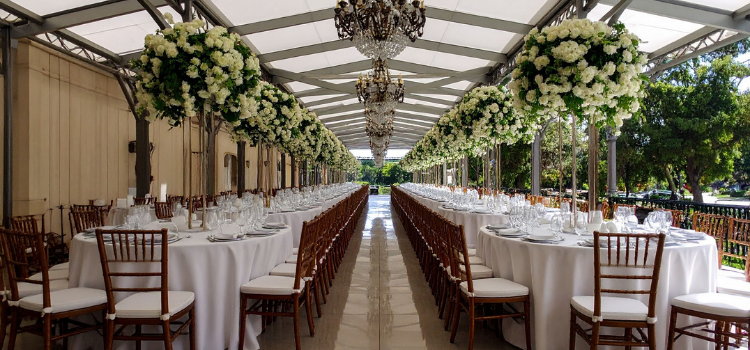 Wedding reception venue with banquet seating, floral décor, and elegant reception setup
