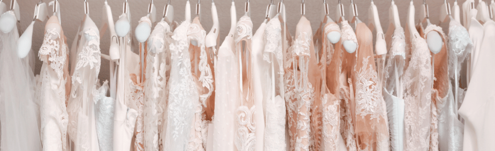 Brides browsing wedding dress collections inside a bridal boutique