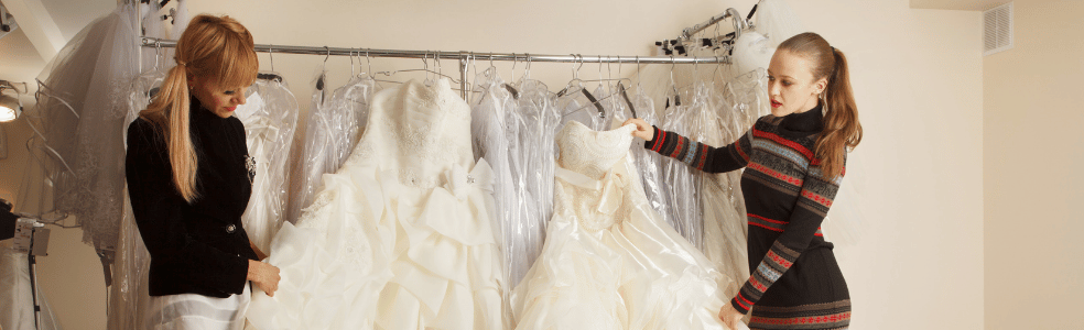 Bridal consultant helping a bride select a wedding dress during an appointment