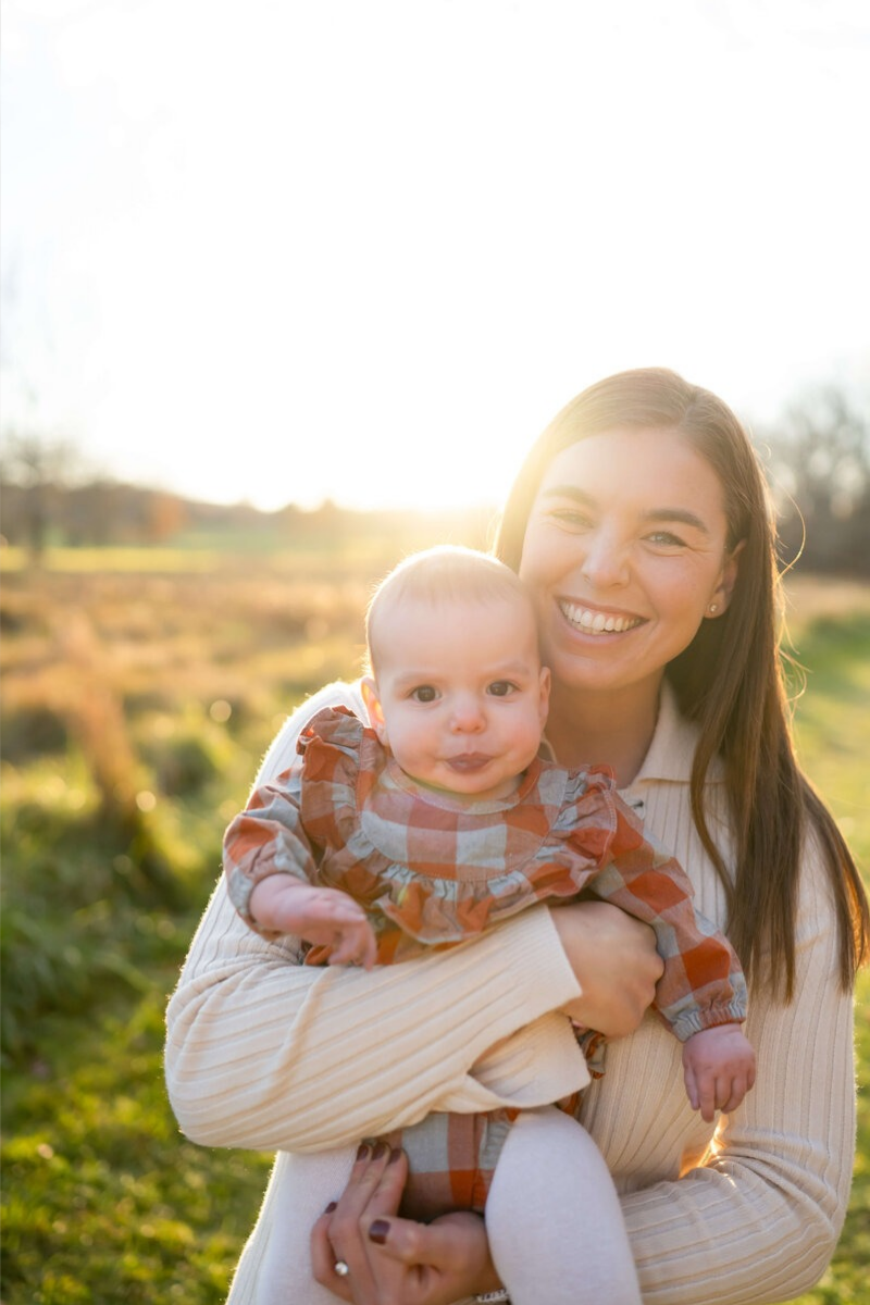 Sleep consultant client case study featuring mom holding baby outdoors showing real families helped with infant sleep training support